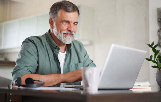 Man on laptop sitting at a table